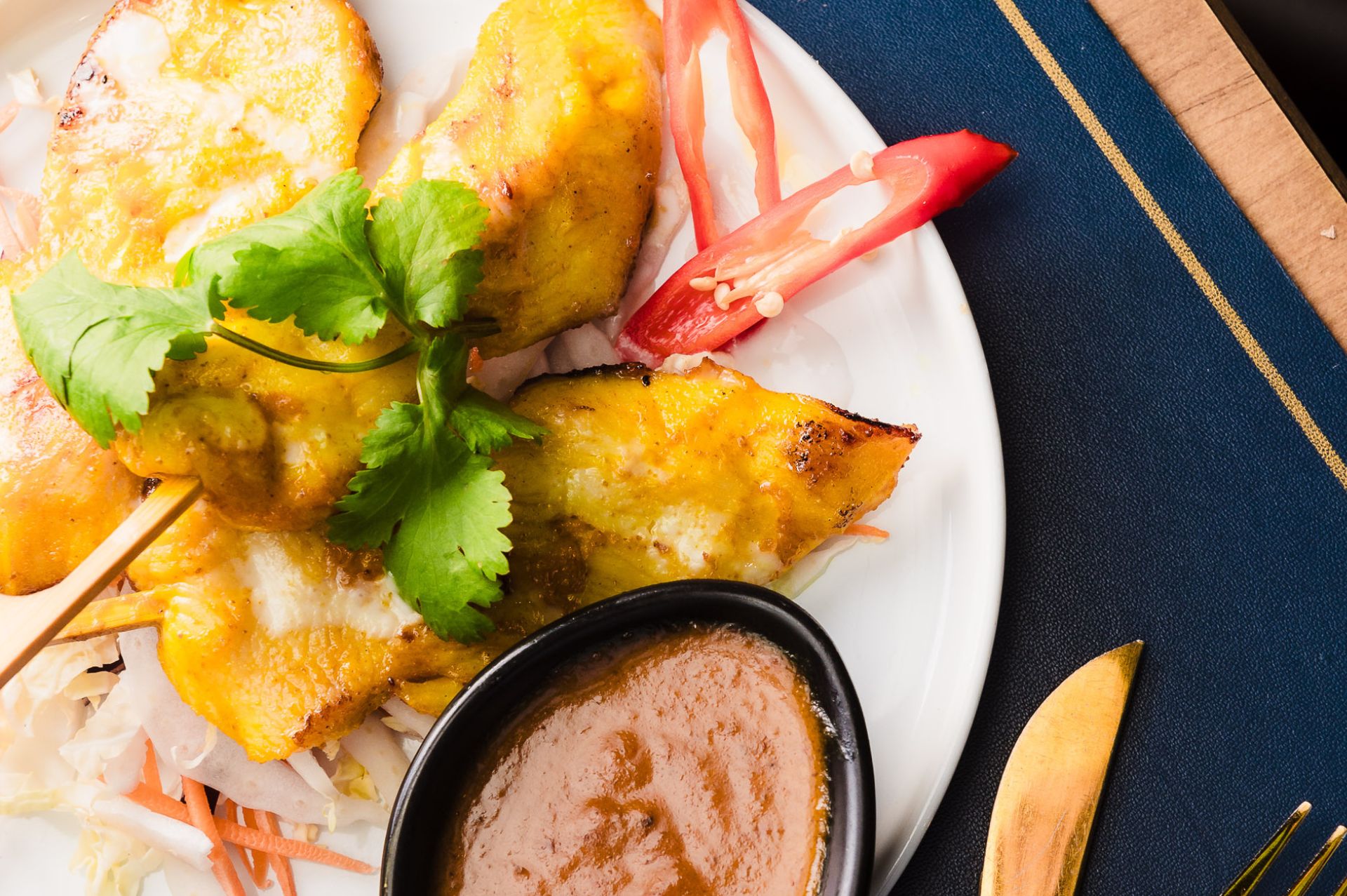 Thai fishcakes being drizzled with sweet chilli sauce